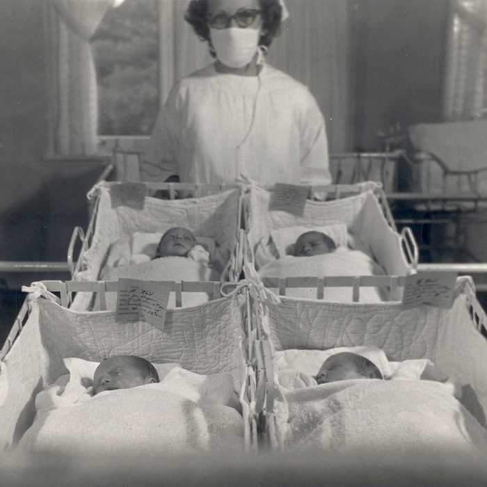 A nurse overlooking four newborns in bassinets at Beaver Dam Community Hospital in July of 1949