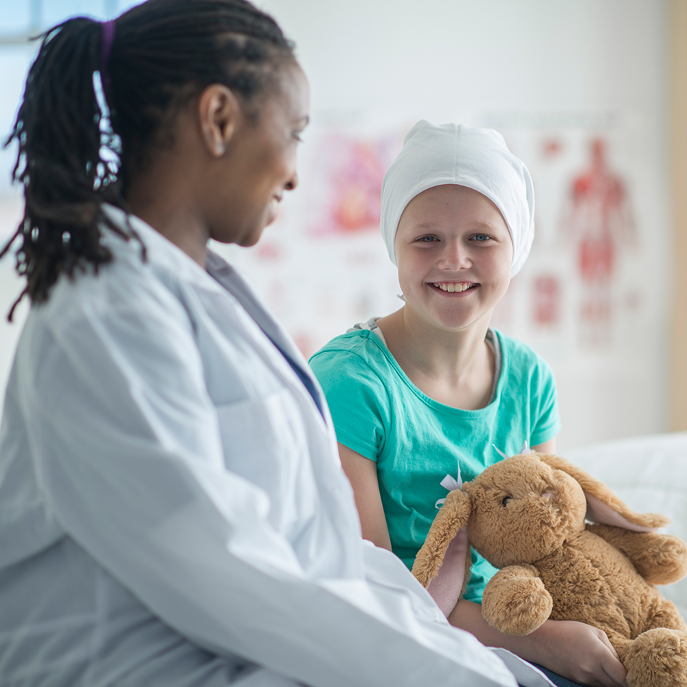 Female nurse with a young girl who is a cancer patient. Beaver Dam Community Hospital cancer services