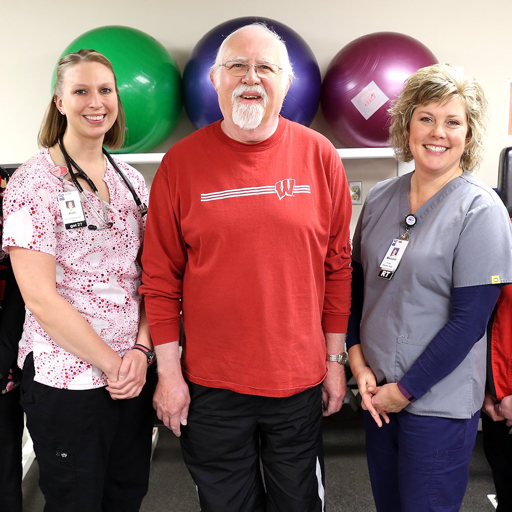 Older male patient with two female providers at Beaver Dam Community Hospital cardiac rehab center